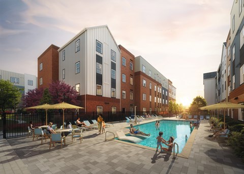 A pool area with people relaxing and swimming in front of a multi-story building.