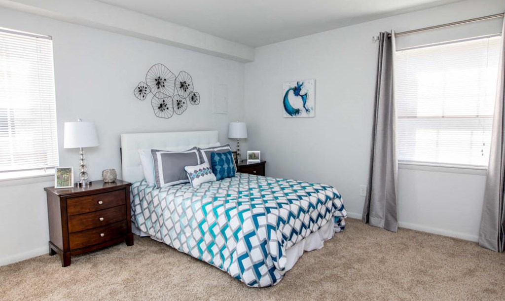 a bedroom with a bed and two night stands