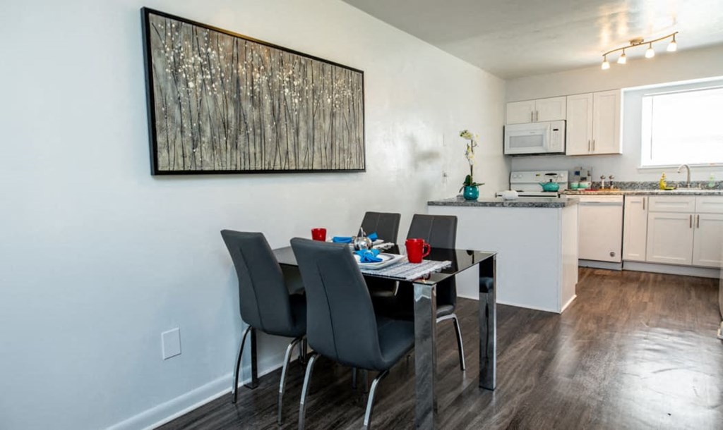 a kitchen and dining room with a table and chairs
