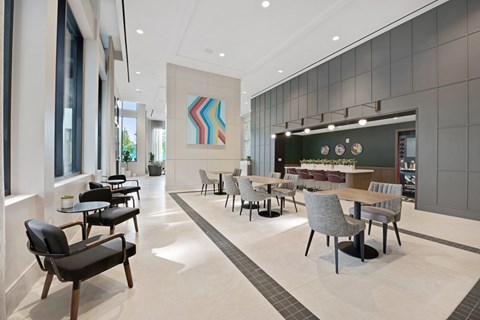 A modern dining room with a long table and chairs.