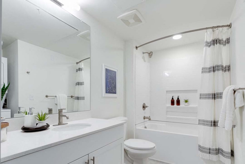 a bathroom with a sink toilet and bathtub