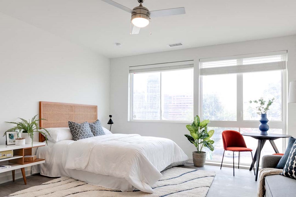 a bedroom with a bed and a ceiling fan