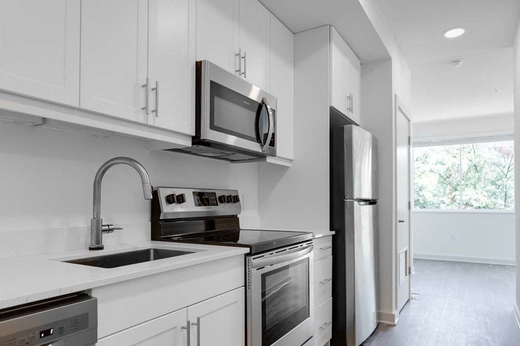 a kitchen with a stove top oven next to a refrigerator