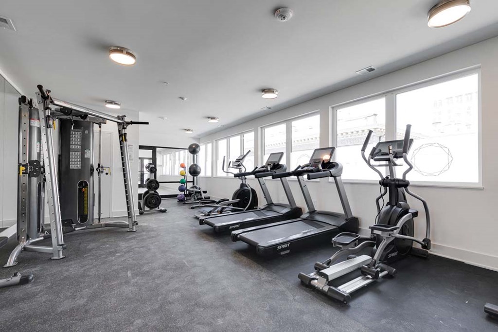 a gym with treadmills and other exercise equipment