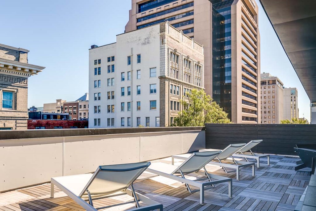a group of chairs sitting on top of a wooden deck