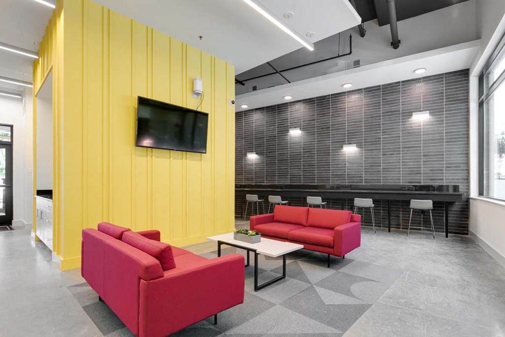 a room with two red couches and a coffee table