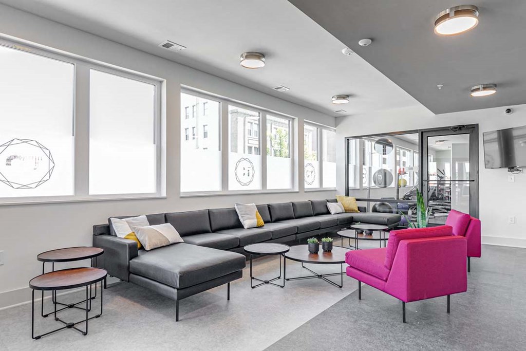 a living room filled with furniture and a large window