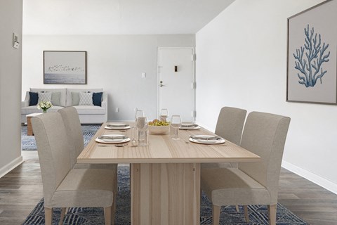 a dining room with a wooden table and chairs