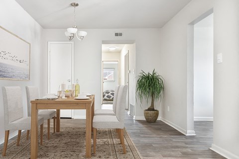 a dining room and living room with a table and chairs