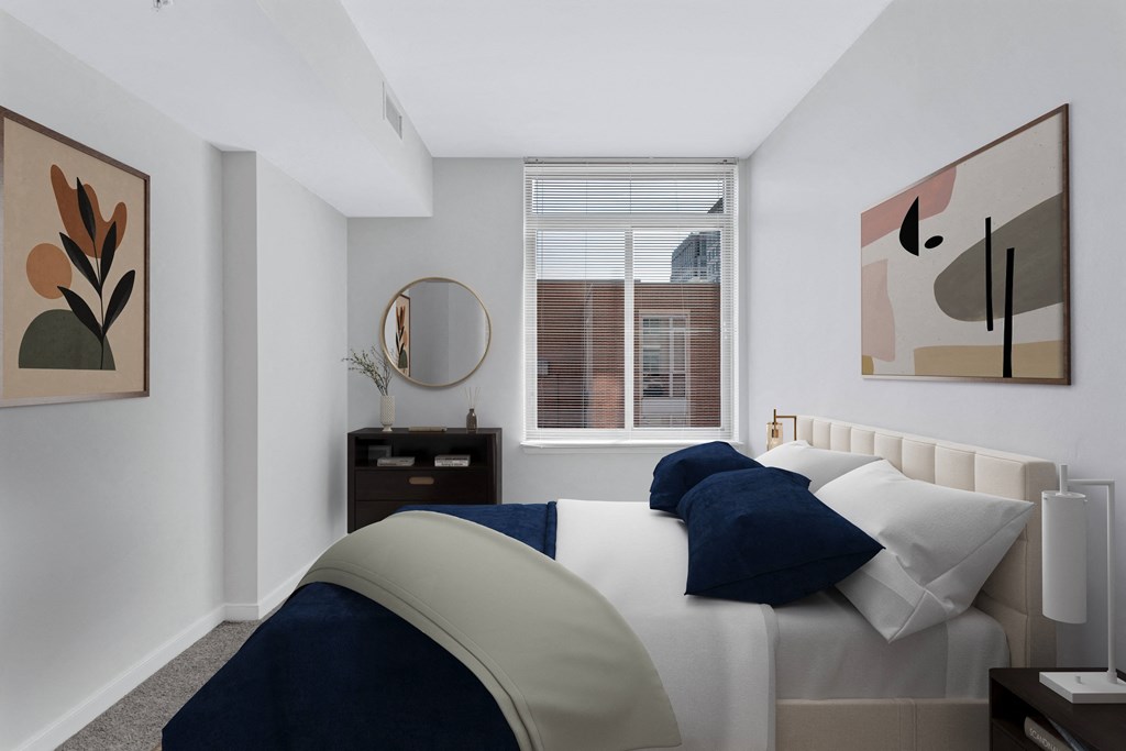 a bedroom with a large bed and a window