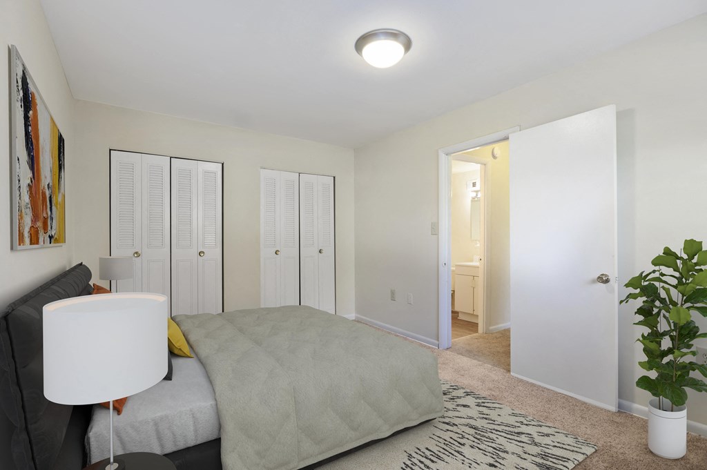 a bedroom with a large bed and a closet with a mirror