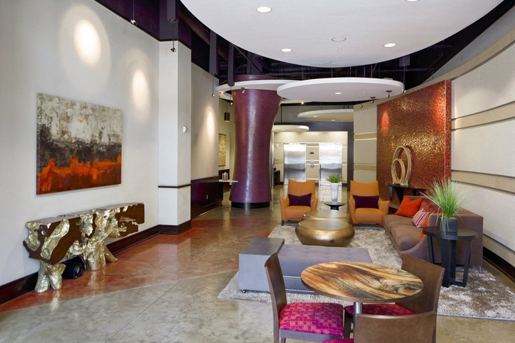 a lobby with a seating area and a table and chairs