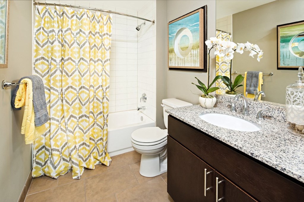 a bathroom with a shower and a sink and a toilet