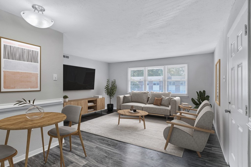 a living room with a couch and a table and chairs