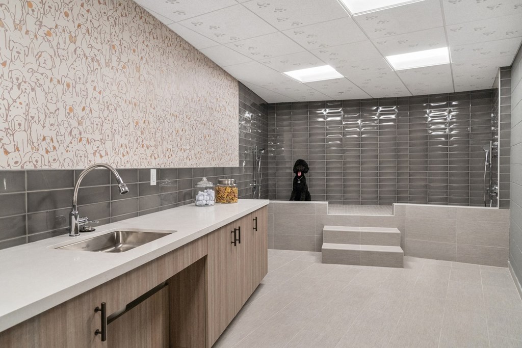 a person taking a picture of a bathroom with a sink and shower