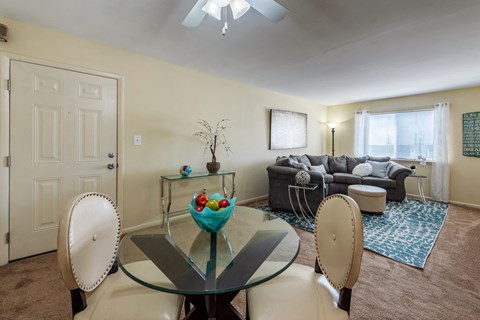 a living room with a table and chairs and a couch