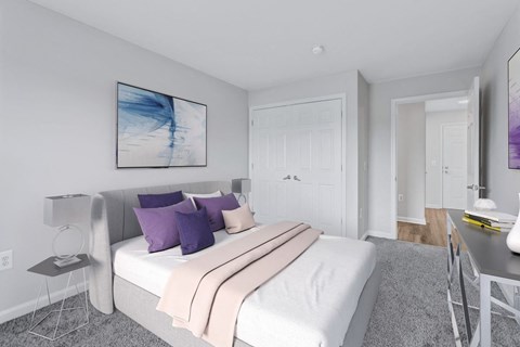 a bedroom with a white bed and purple pillows