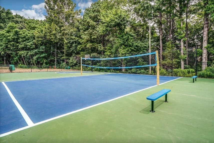 a tennis court with a bench and a net on it