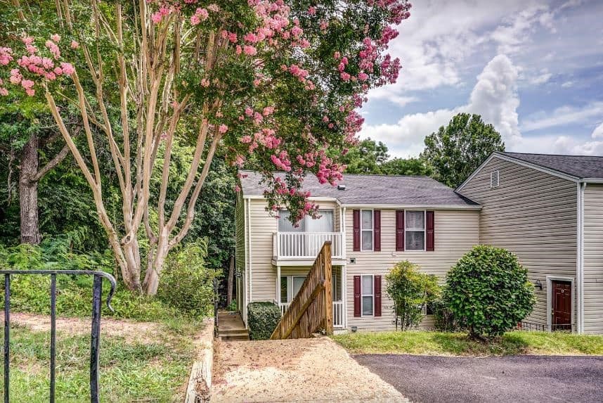 a white house with a tree in front of it