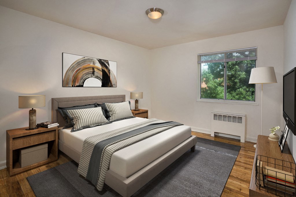 a bedroom with a white bed and a tv