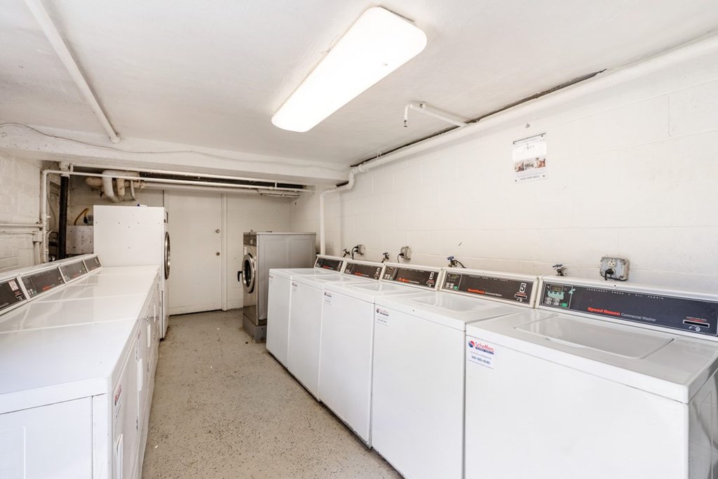A laundry room with washers and dryers.