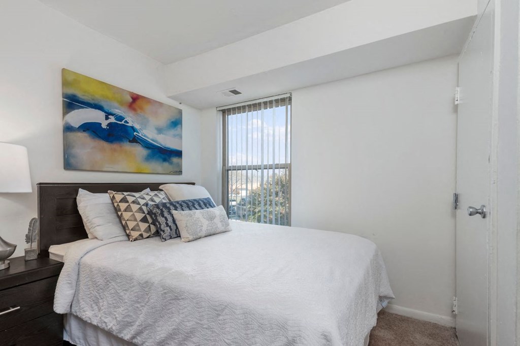 a bedroom with a bed and a window