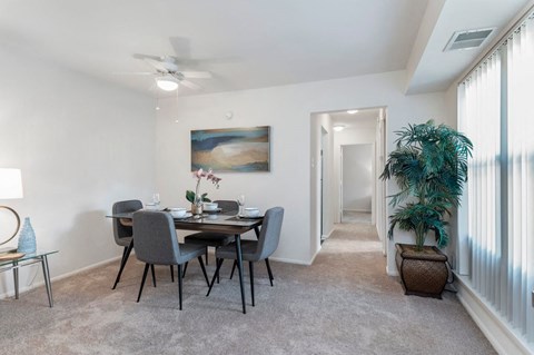 a dining room with a table and chairs and a ceiling fan