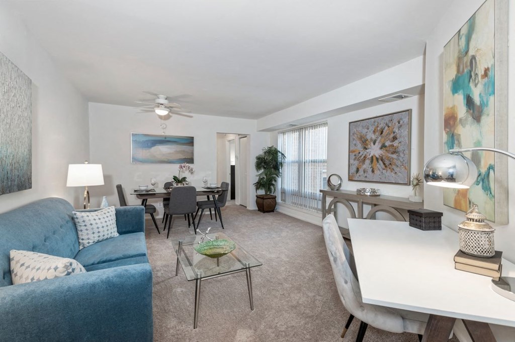 a living room and dining room with a couch and a table