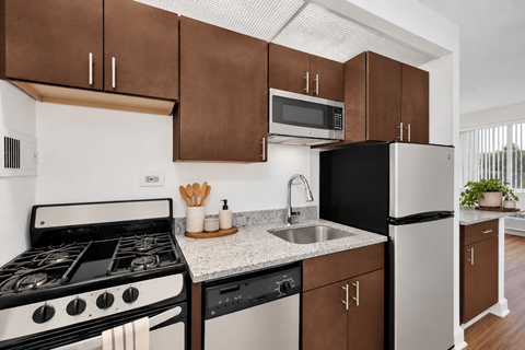 A modern kitchen with a black oven and a white stove.