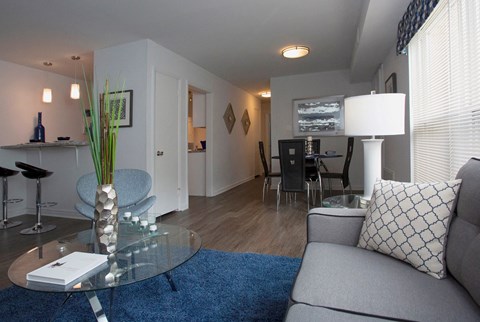 a living room with a couch and a glass table