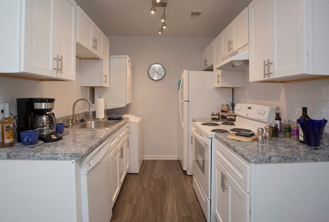 a kitchen with white appliances and granite counter tops