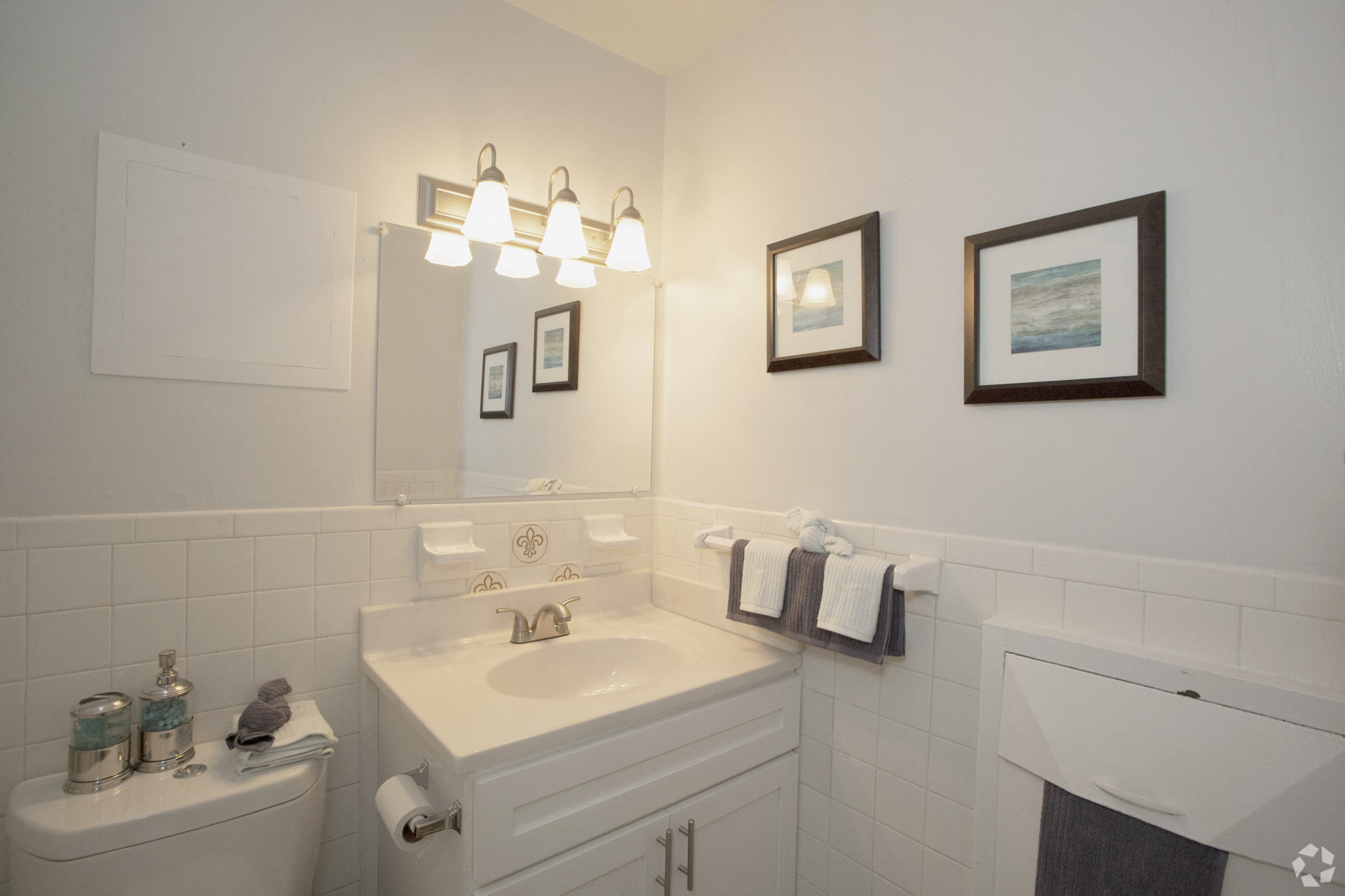 a bathroom with a white sink and a white toilet