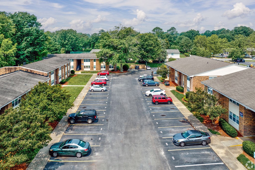 an aerial view of a neighborhood with cars parked in a parking lot