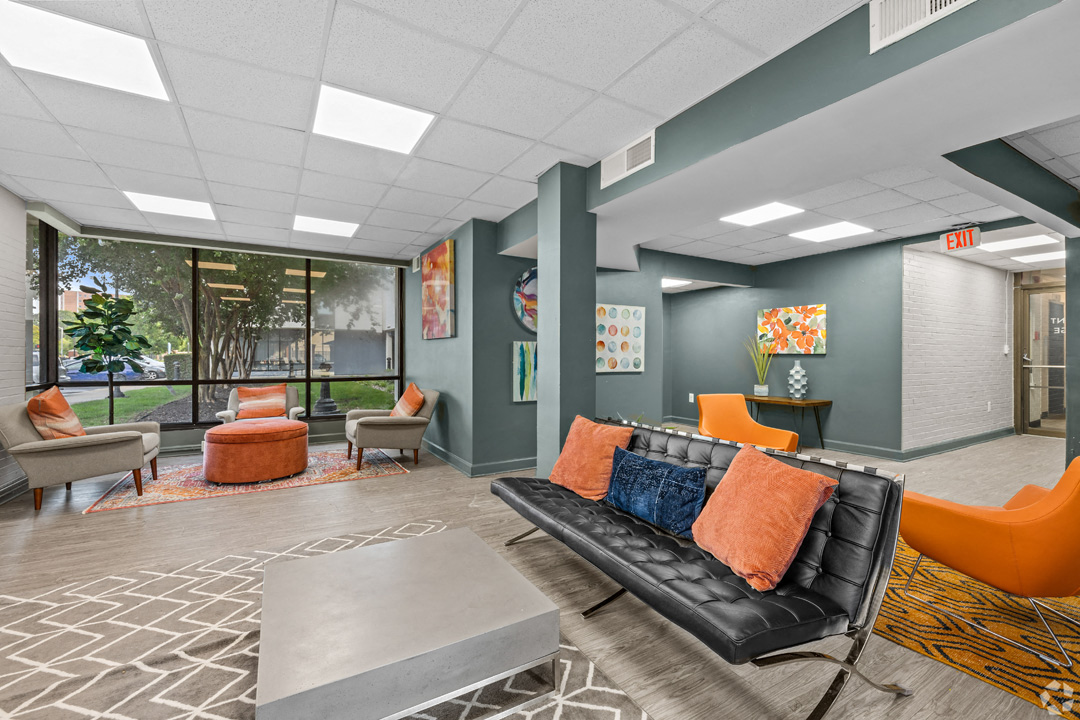 a lobby with a couch and chairs and a table