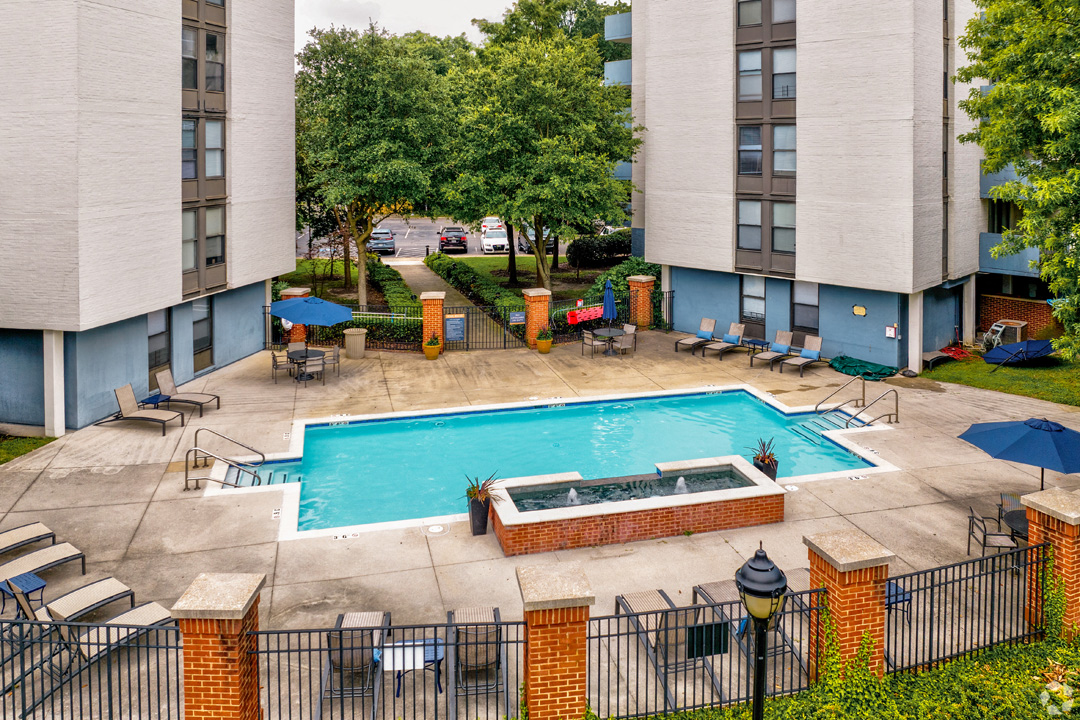 an aerial view of a swimming pool and spa in the courtyard of a hotel building