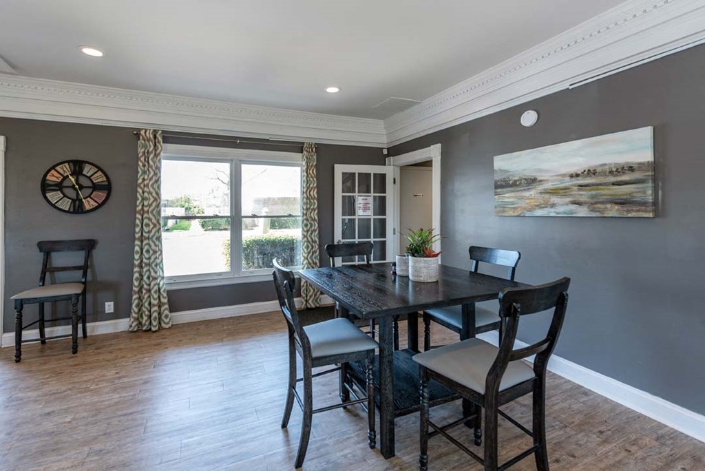 a dining room with a table and chairs