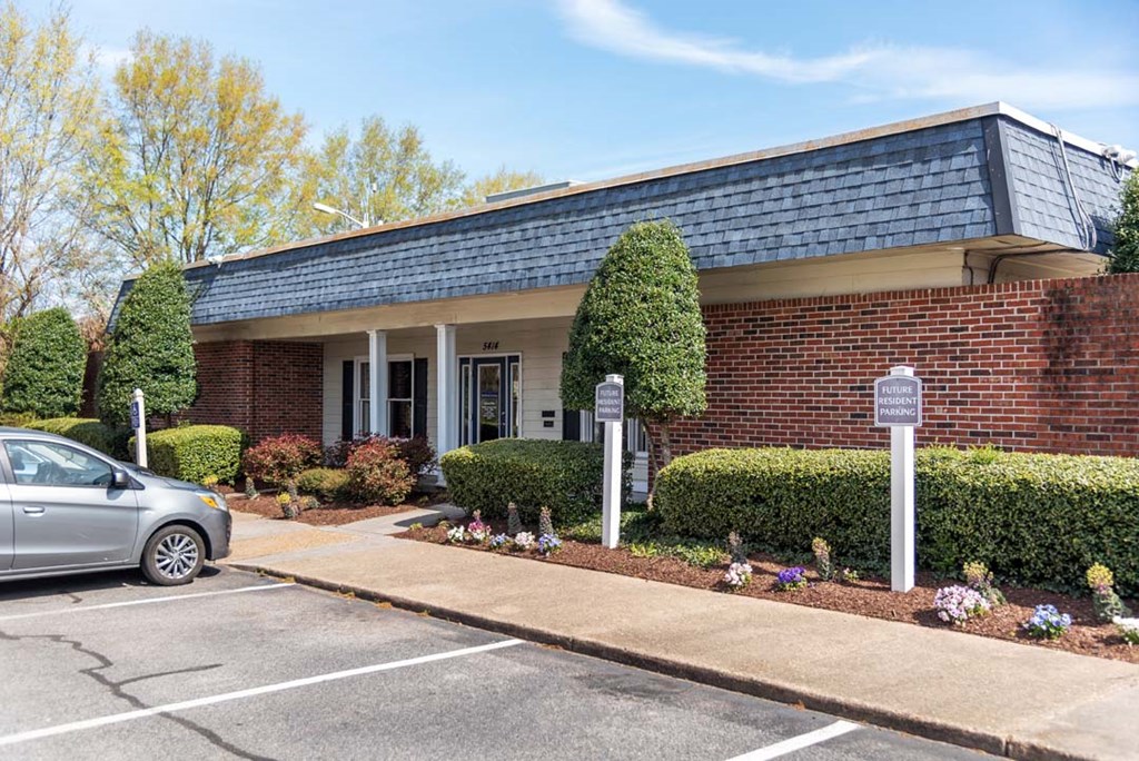 a building with a car parked in a parking lot