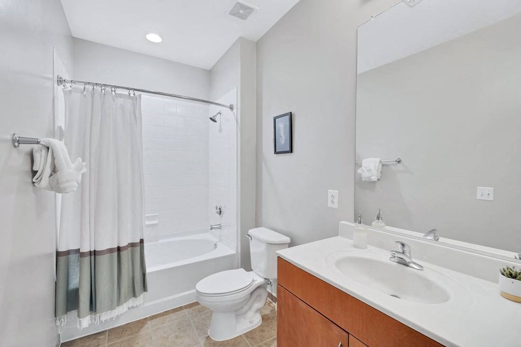 a bathroom with a toilet sink and shower