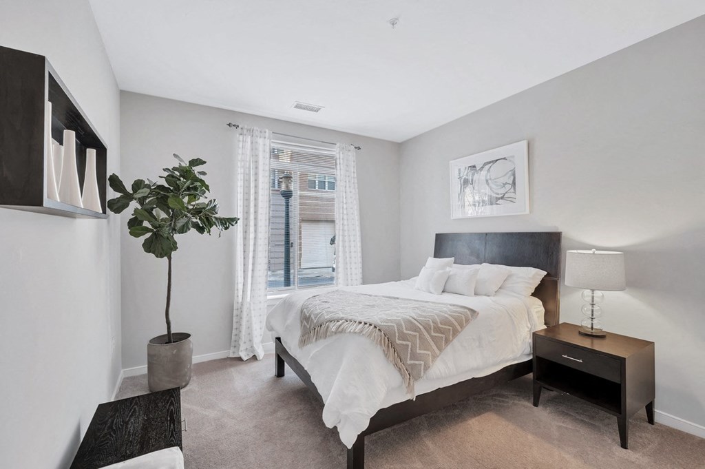 a bedroom with a large bed and a window