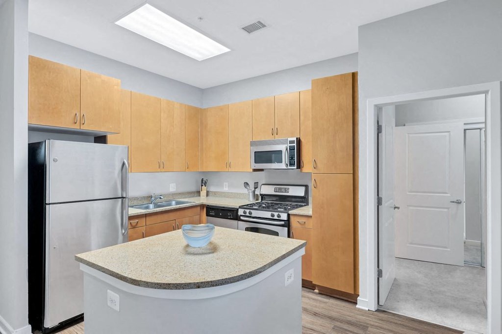a kitchen with wooden cabinets and stainless steel appliances