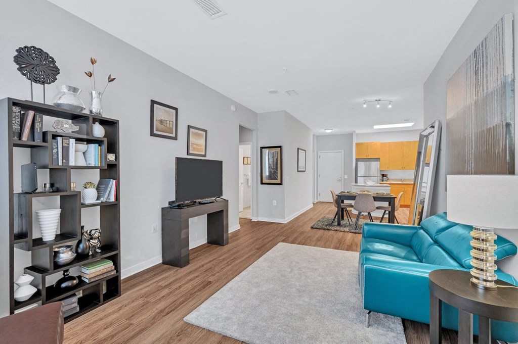 a living room with a blue couch and a tv on a stand
