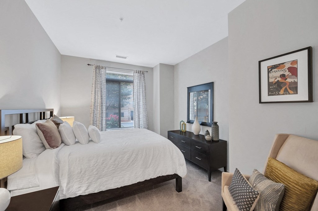 a bedroom with a large bed and a large window