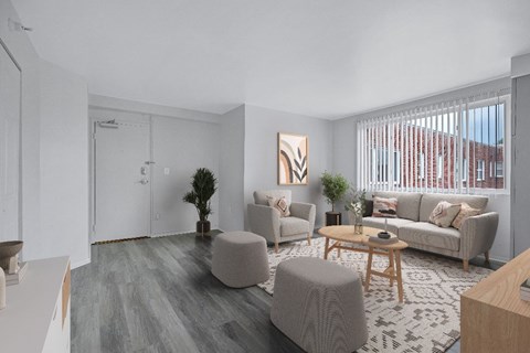 A living room with a grey couch, a wooden coffee table, and a painting on the wall.