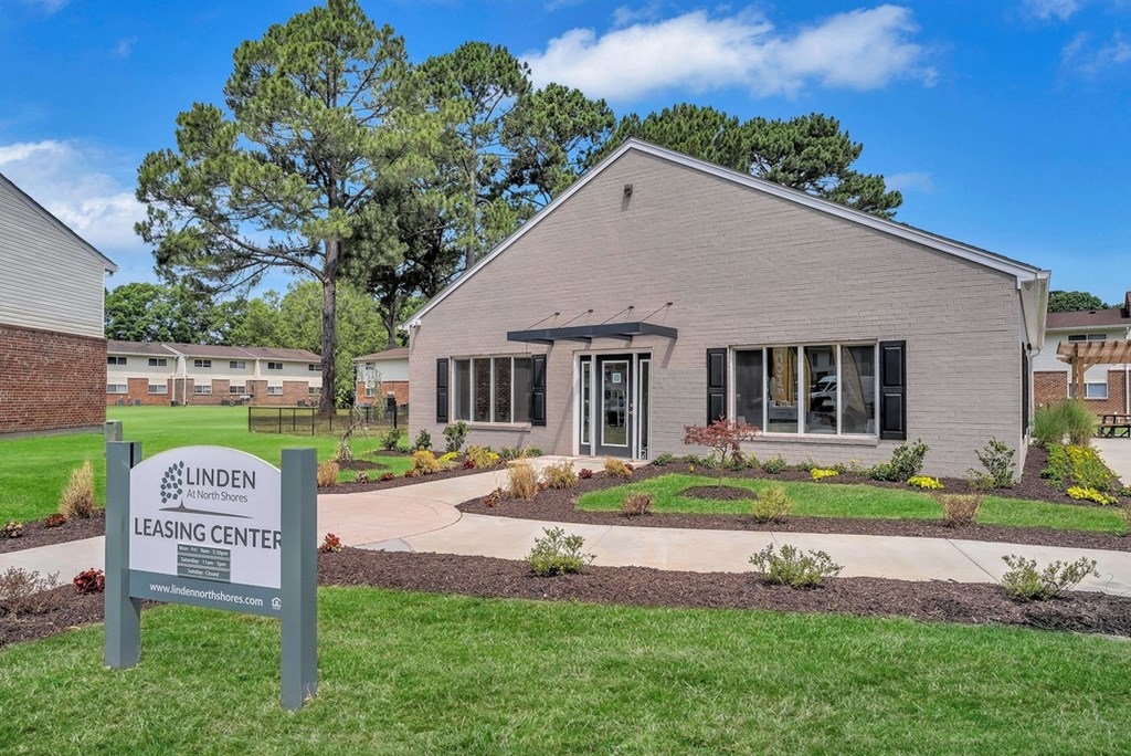 a building with a leasing center sign in front of it