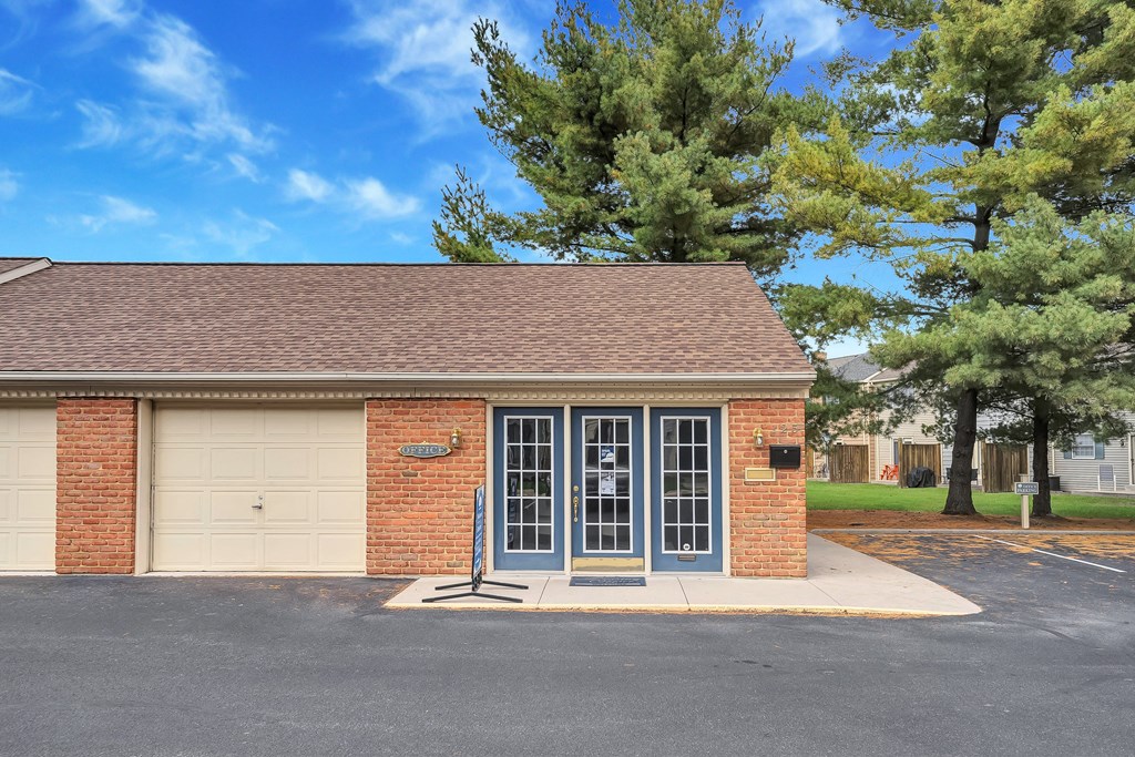 a small brick building with a white garage door