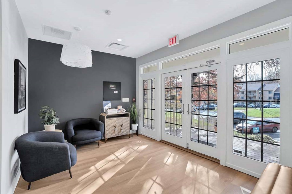 a living room with two chairs and a door to the street