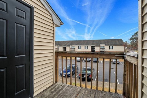 the view from the front door of a house with a parking lot