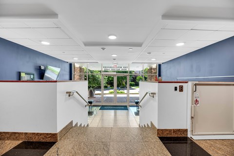 A lobby with a pool table and a white door.