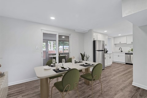 A modern kitchen with a dining table and chairs.