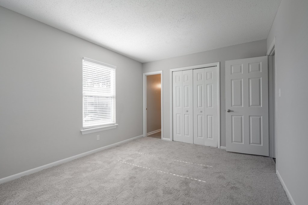 A room with two doors and a window.